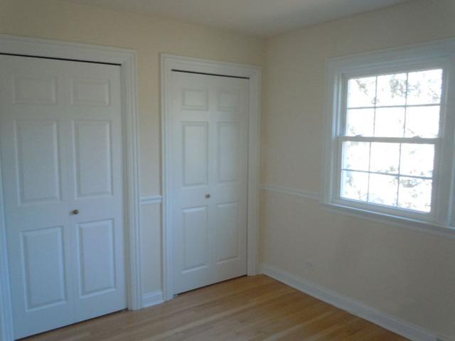 1752 East Corktree Lane Mount Prospect, IL 60056 - Photo 13 of 20 an empty room with wooden floor and windows