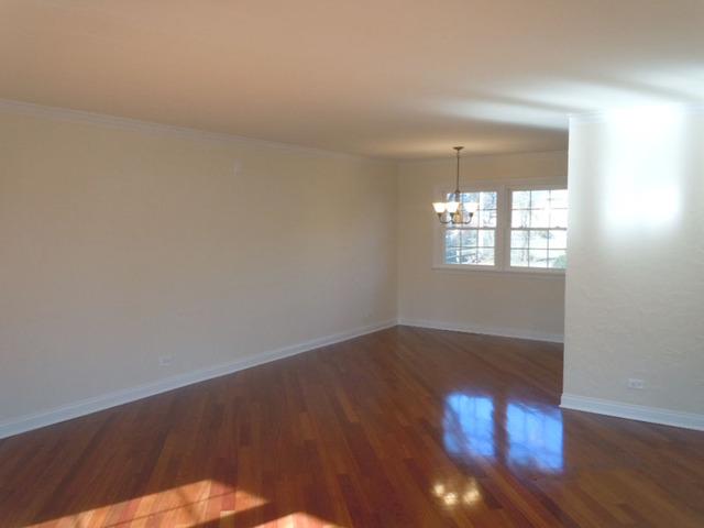 1752 East Corktree Lane Mount Prospect, IL 60056 - Photo 4 of 20 an empty room with wooden floor and windows