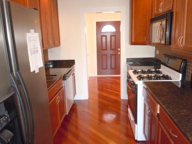 1752 East Corktree Lane Mount Prospect, IL 60056 - Photo 5 of 20 a kitchen with granite countertop a refrigerator a sink and wooden floors