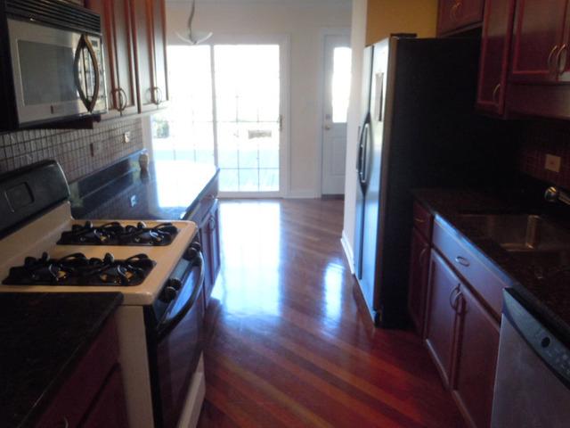 1752 East Corktree Lane Mount Prospect, IL 60056 - Photo 6 of 20 a kitchen with wooden floor and a stove top oven