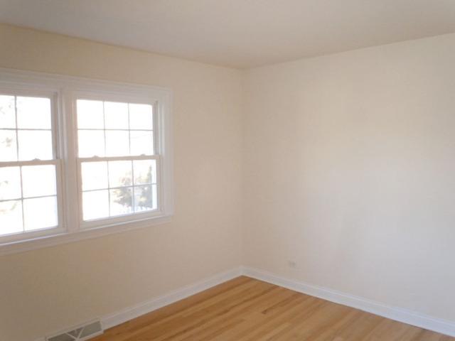 1752 East Corktree Lane Mount Prospect, IL 60056 - Photo 10 of 20 an empty room with a window