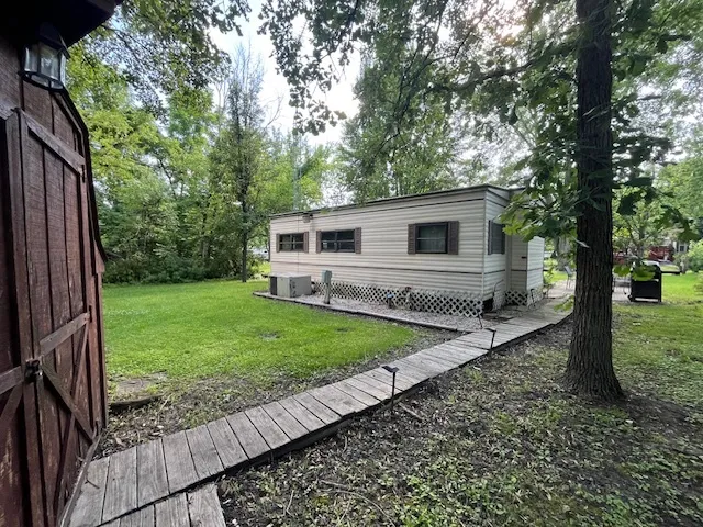 a pathway of a house with a yard