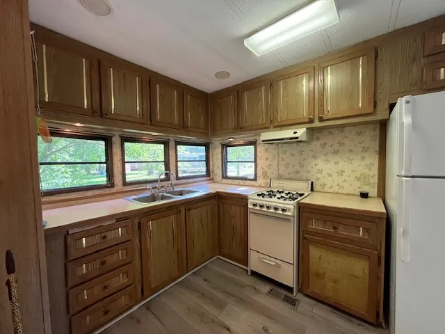 a kitchen with granite countertop stainless steel appliances and wooden cabinets