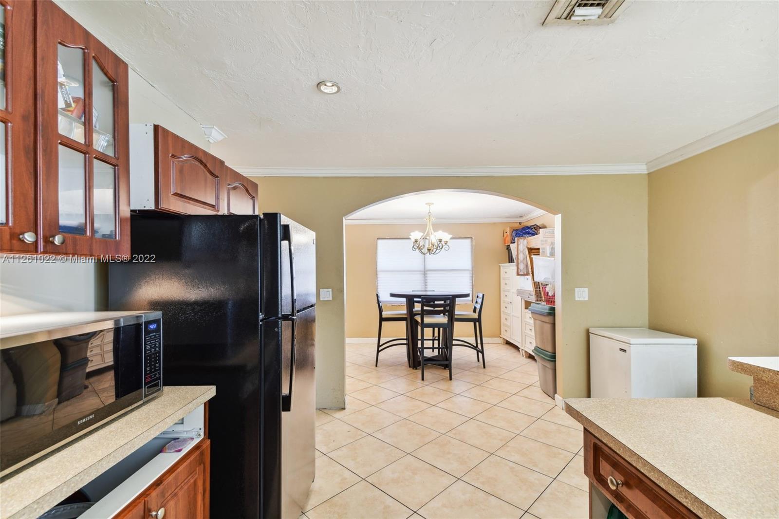3008 Dunlin Road Delray Beach, FL 33444 - Photo 9 of 30 a kitchen with stainless steel appliances granite countertop a refrigerator and a stove top oven