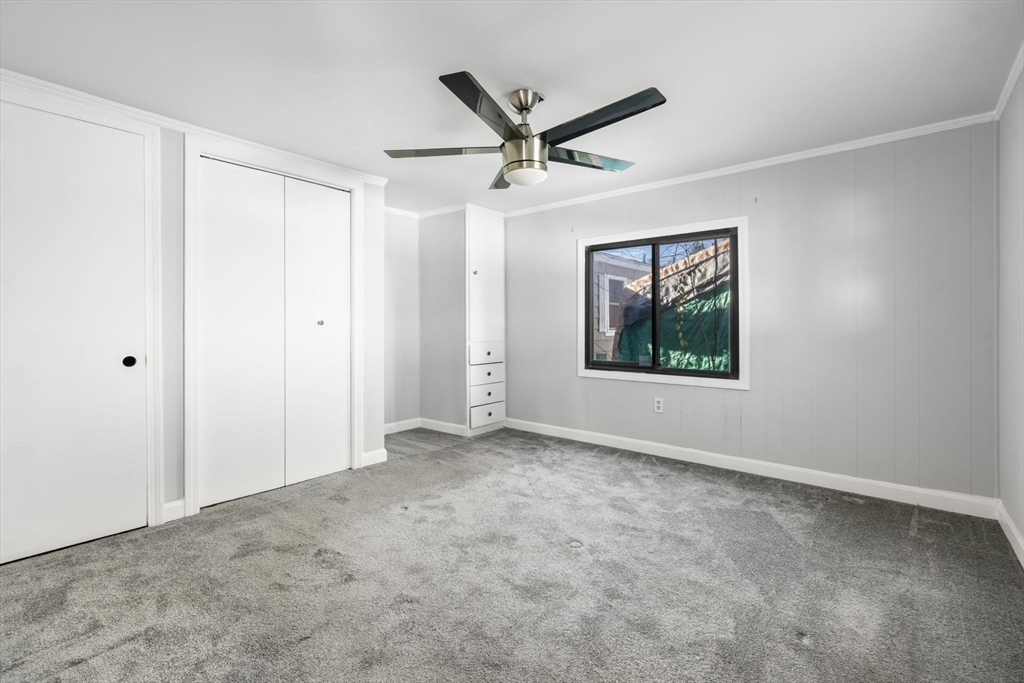 75 South Policy Street, Unit 48 Salem, NH 03079 - Photo 24 of 36 a view of a livingroom with a ceiling fan & windows