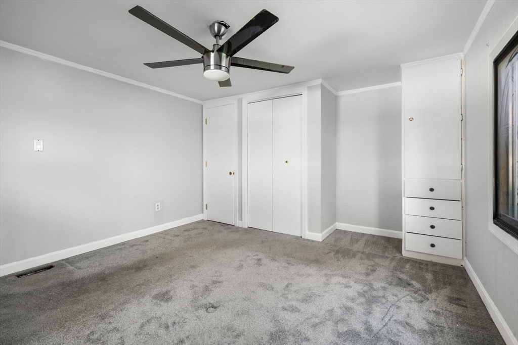 75 South Policy Street, Unit 48 Salem, NH 03079 - Photo 25 of 36 an empty room with closet and wooden floor