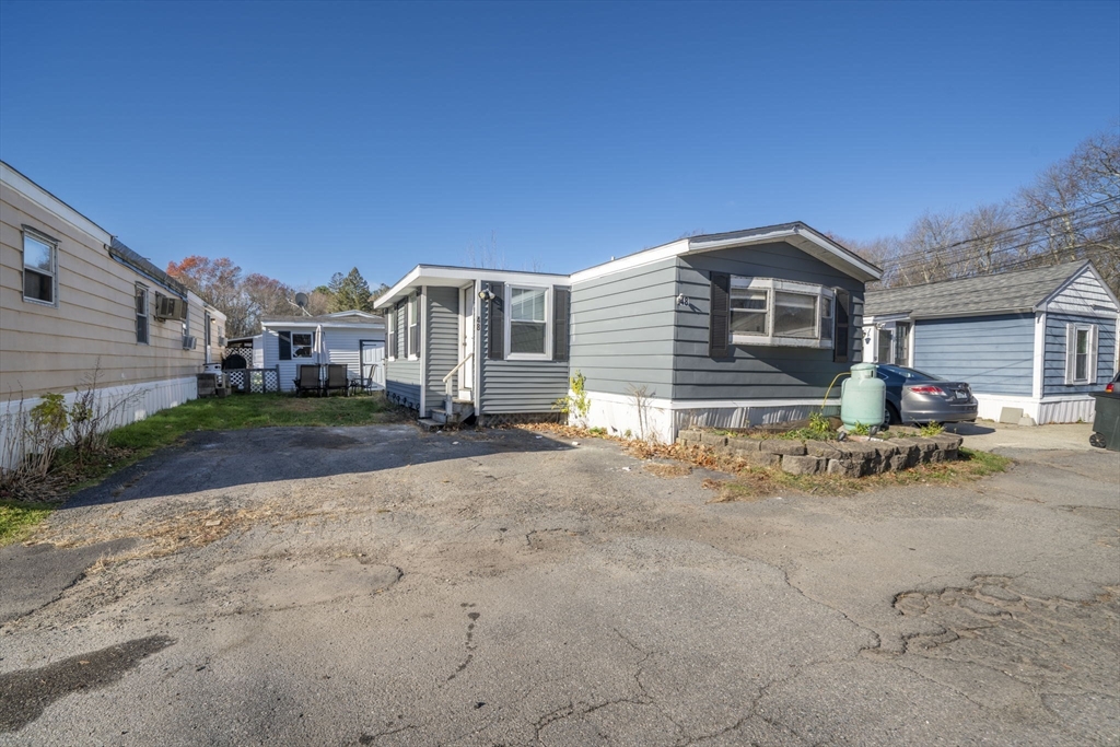 75 South Policy Street, Unit 48 Salem, NH 03079 - Photo 27 of 36 a front view of a house with a yard and garage