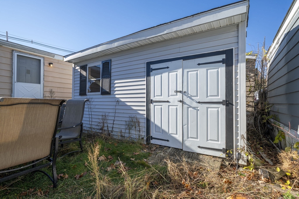 75 South Policy Street, Unit 48 Salem, NH 03079 - Photo 30 of 36 a backyard of a house with wooden floor and fence