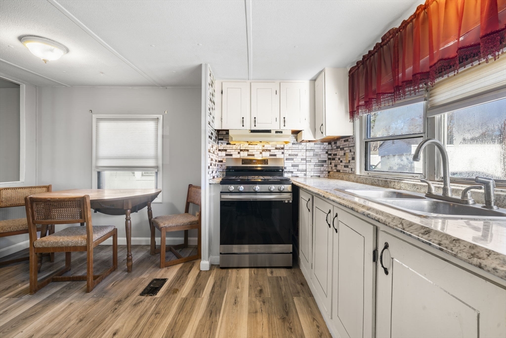 75 South Policy Street, Unit 48 Salem, NH 03079 - Photo 3 of 36 a kitchen with a stove a sink and a refrigerator