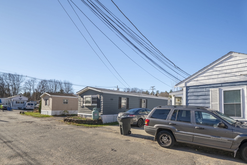 75 South Policy Street, Unit 48 Salem, NH 03079 - Photo 32 of 36 a view of a car parked in front of a house