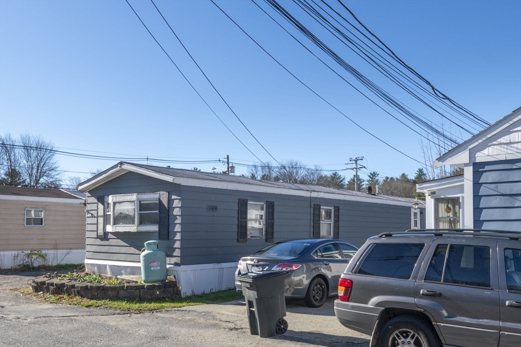 75 South Policy Street, Unit 48 Salem, NH 03079 - Photo 33 of 36 a front view of a house with parking space