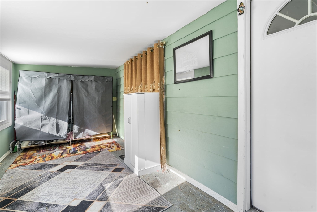 75 South Policy Street, Unit 48 Salem, NH 03079 - Photo 7 of 36 a room with a door and a window