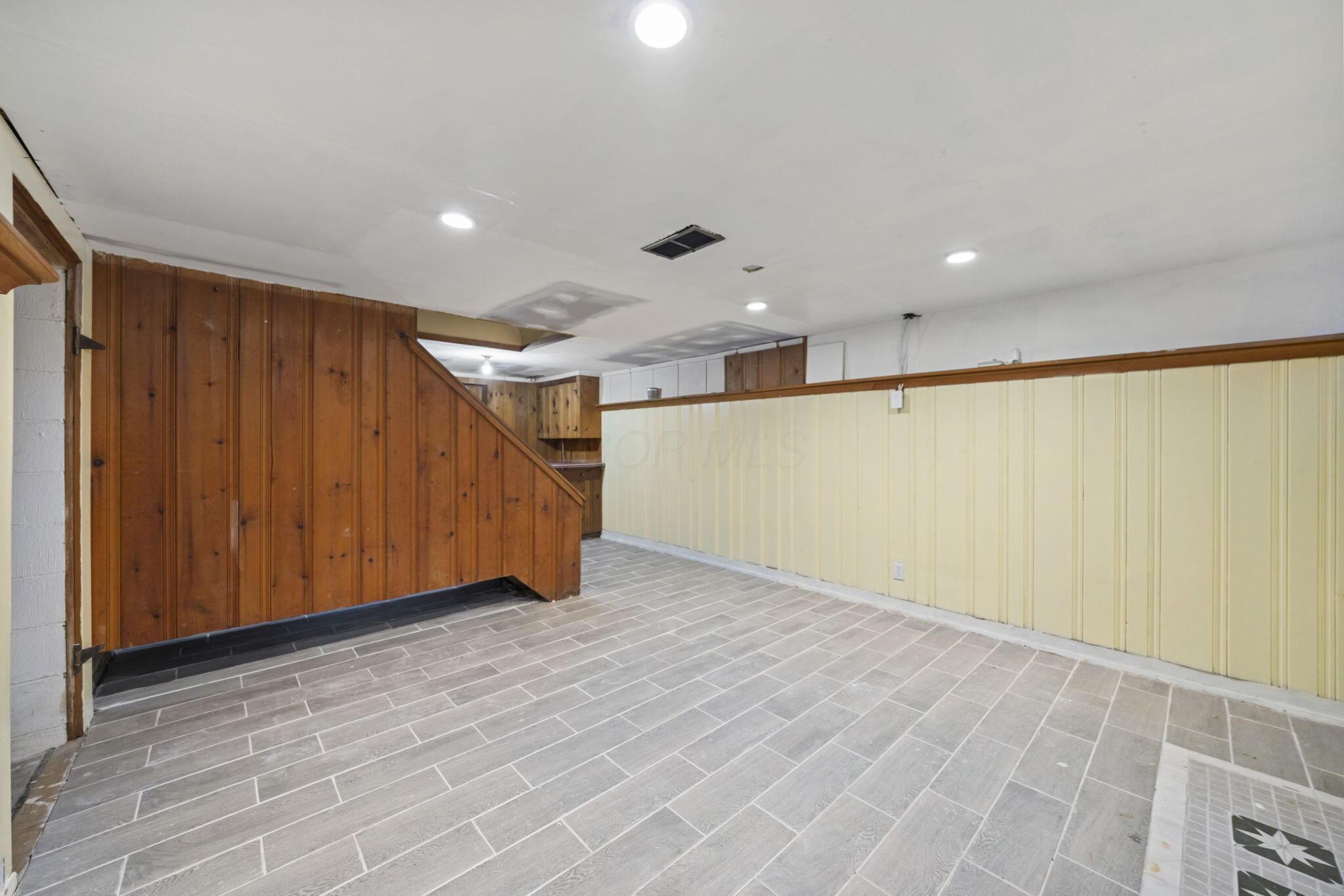40 South Kellner Road Columbus, OH 43209 - Photo 34 of 57 Tiled flooring, wood paneling, recessed lighting, and built-in shelving