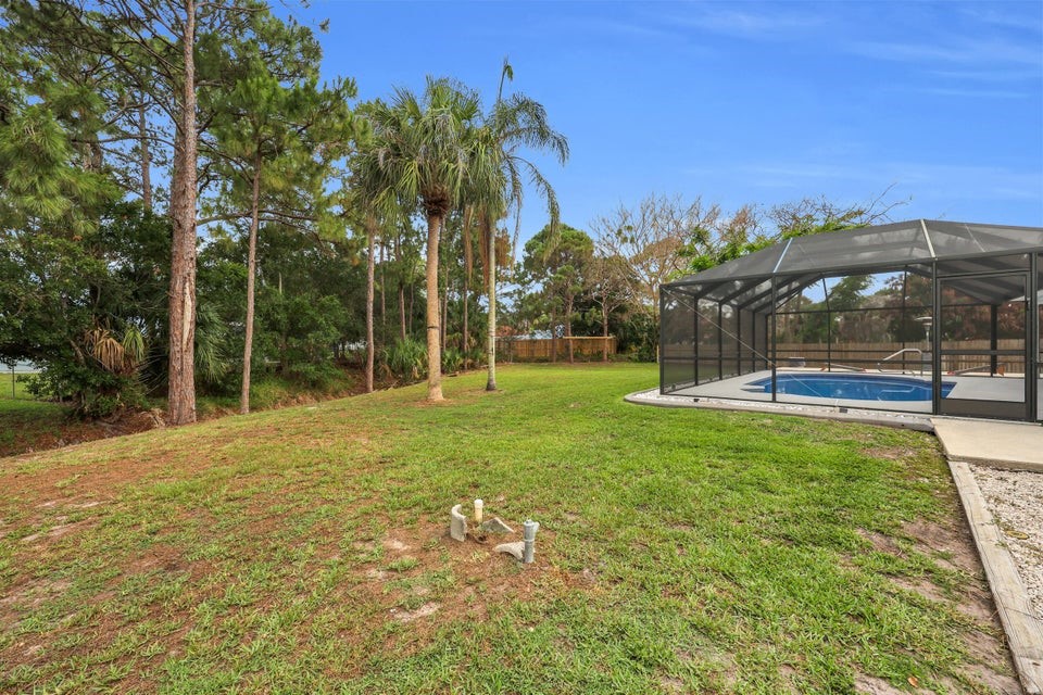 1950 Southwest Logwood Road Port St. Lucie, FL 34953 - Photo 29 of 32 a view of outdoor space with garden and trees