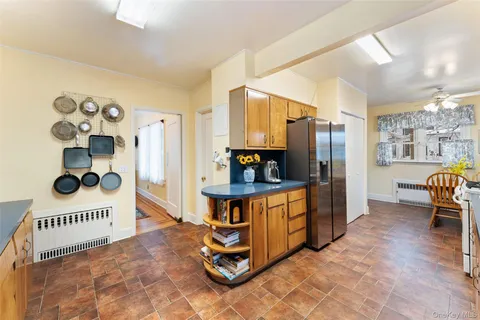 a view of a hallway with workspace and windows