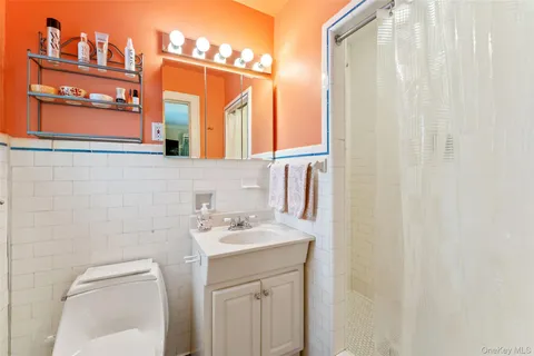 a bathroom with a sink a toilet and shower curtain