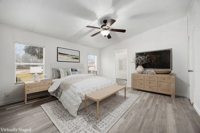 a bed room with furniture and a flat screen tv