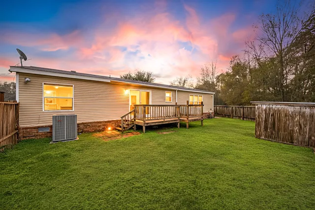 a view of a backyard with a garden and deck