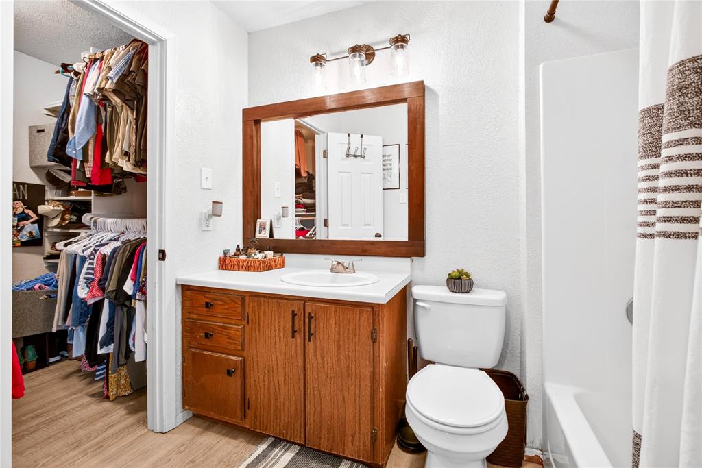 703 College Street Celeste, TX 75423 - Photo 16 of 29 a bathroom with a toilet a sink and a mirror