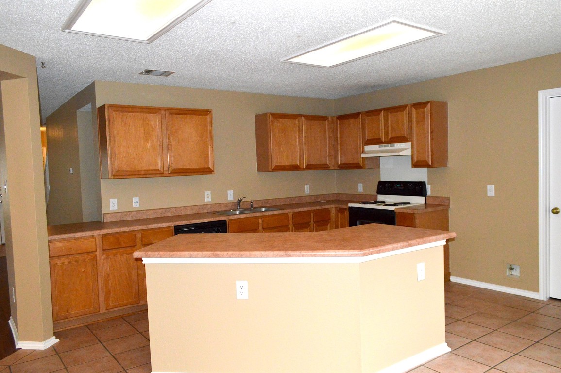 2014 Carriage Club Drive Cedar Park, TX 78613 - Photo 1 of 19 a kitchen with stainless steel appliances granite countertop a sink a stove and a refrigerator