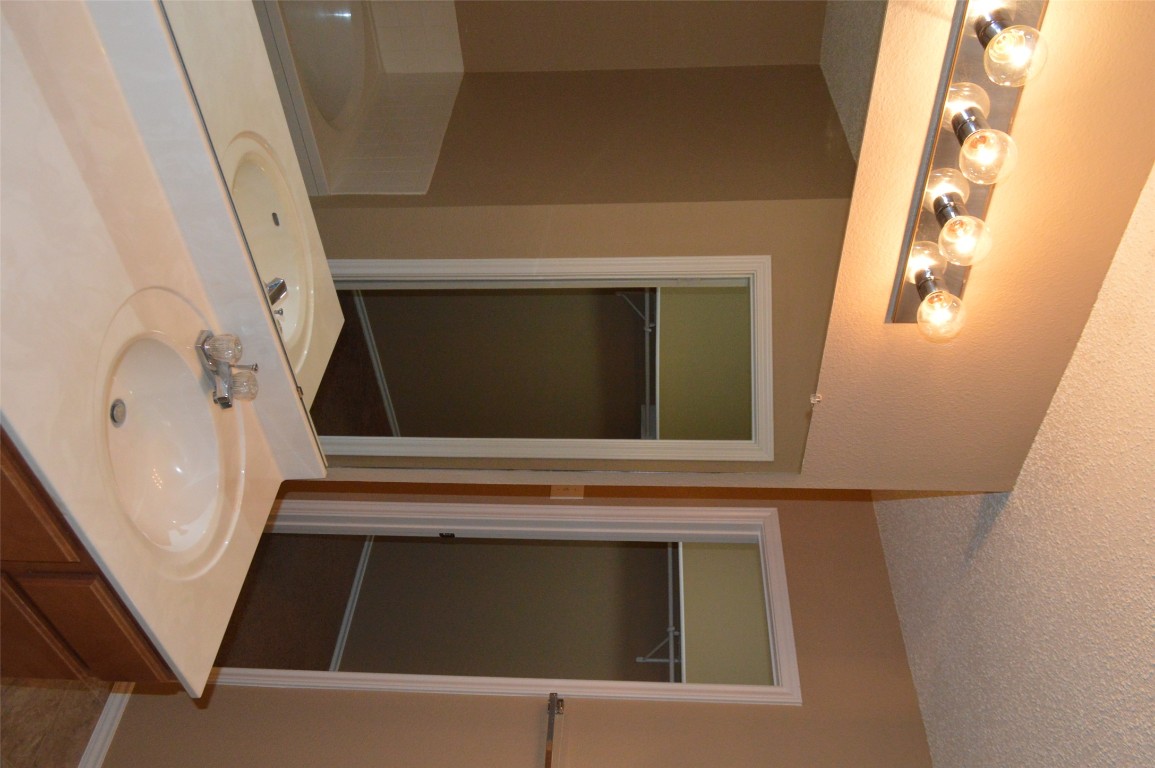 2014 Carriage Club Drive Cedar Park, TX 78613 - Photo 18 of 19 a bathroom with a sink and a mirror