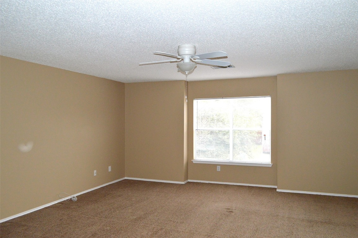 2014 Carriage Club Drive Cedar Park, TX 78613 - Photo 19 of 19 an empty room with windows and fan