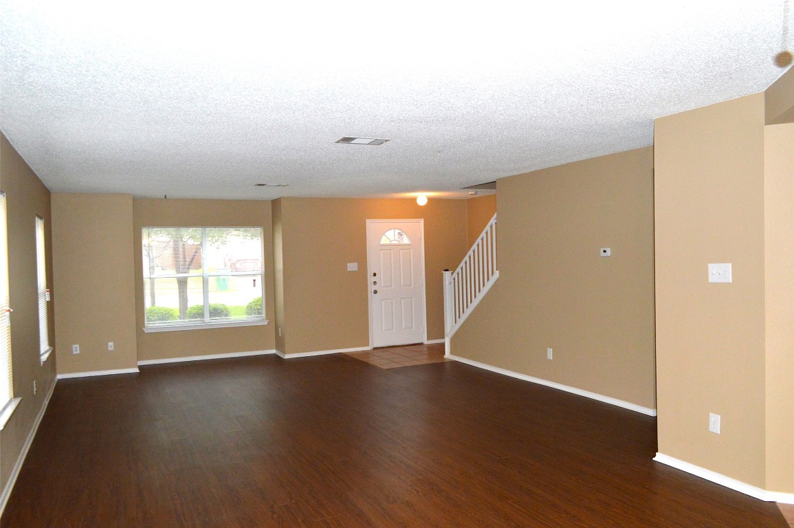 2014 Carriage Club Drive Cedar Park, TX 78613 - Photo 5 of 19 an empty room with wooden floor and windows