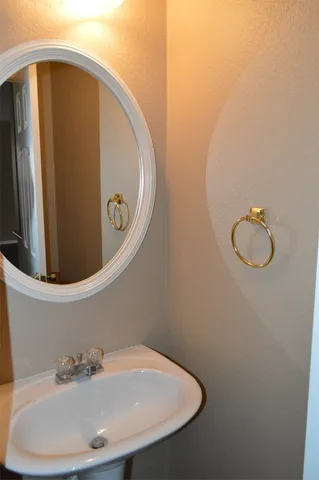 a bathroom with a sink and mirror