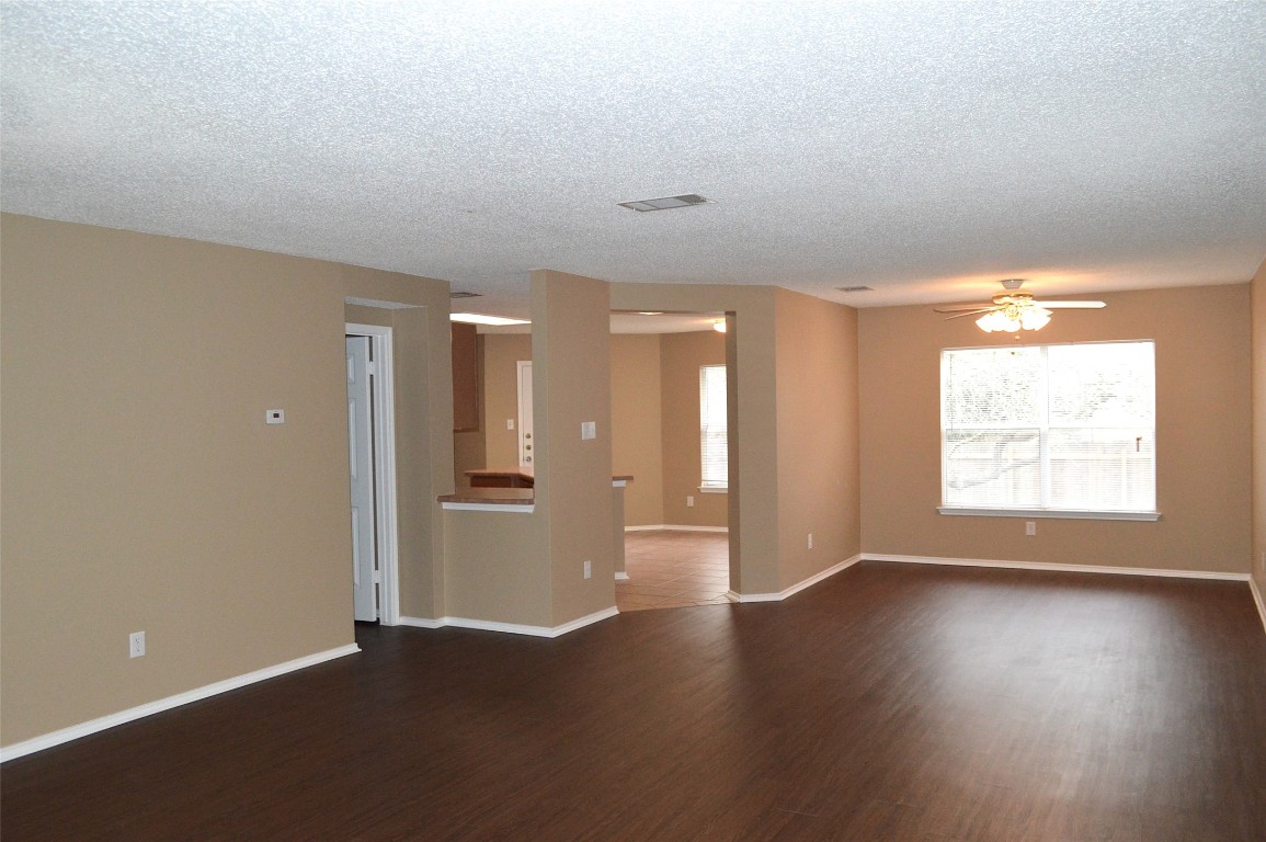 2014 Carriage Club Drive Cedar Park, TX 78613 - Photo 9 of 19 an empty room with wooden floor and windows