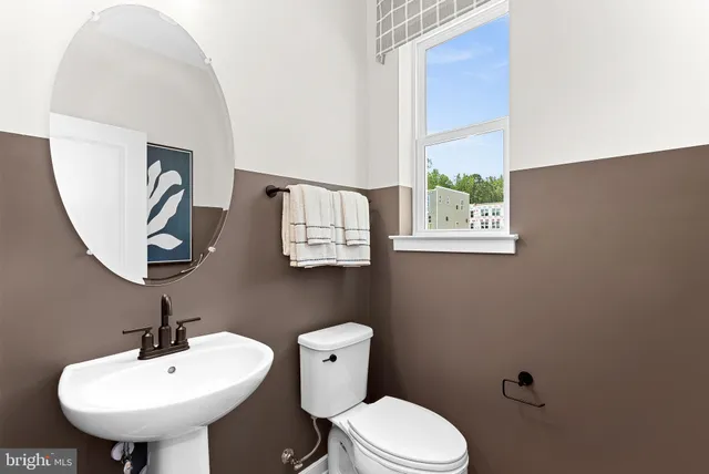 a bathroom with a sink a mirror and a toilet