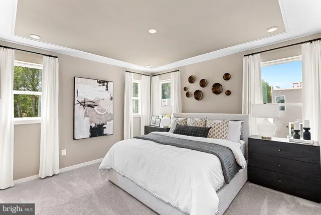a bedroom with a double vanity sink and a mirror