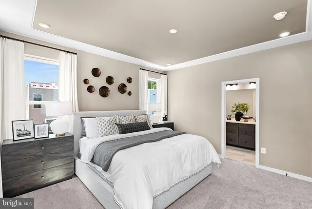 a bedroom with a large bed and a mirror