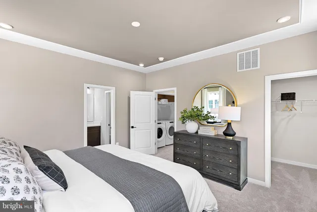 a bedroom with a bed and a dresser