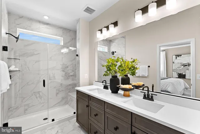 a bathroom with a shower sink and mirror