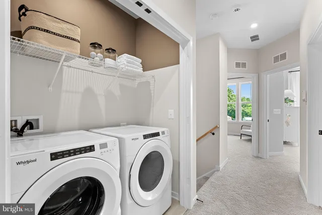 a view of a storage & utility room with dryer and washer