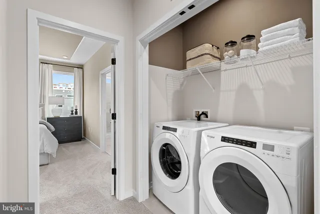 a view of a hallway with washer and dryer