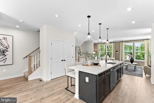 a kitchen with a stove and a wooden floor