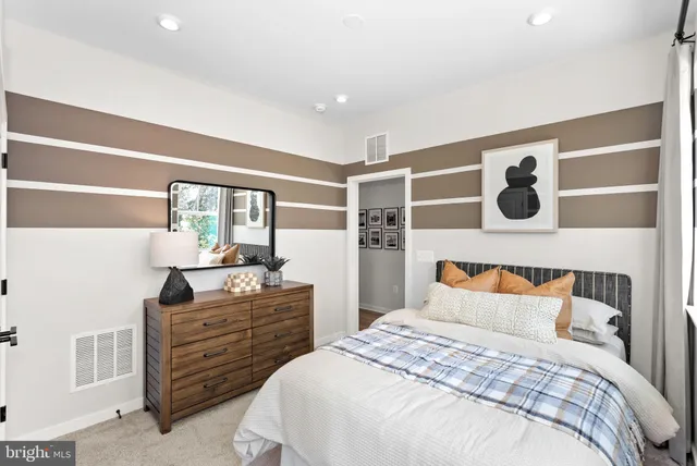 a bedroom with a bed and a dresser