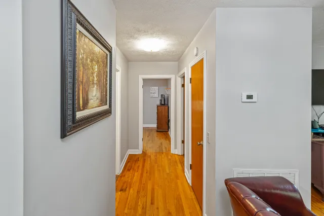 a view of bedroom with a bed and wooden floor