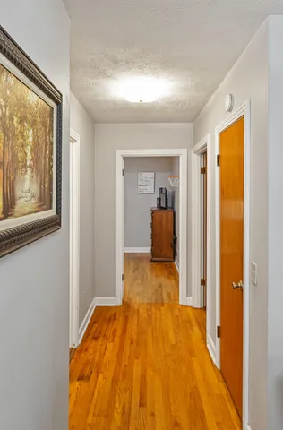 a view of a bedroom with bed and wooden floor