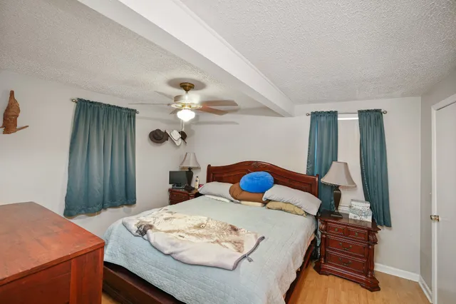 a bedroom with a bed and a chandelier