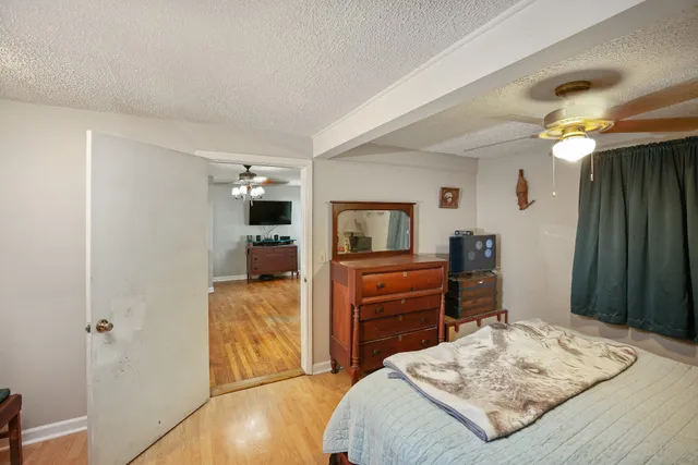 a bedroom with a bed and a dresser in it