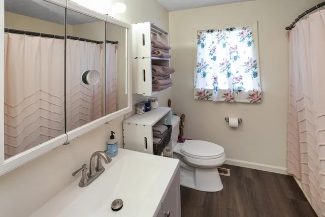 a bathroom with a sink toilet and shower