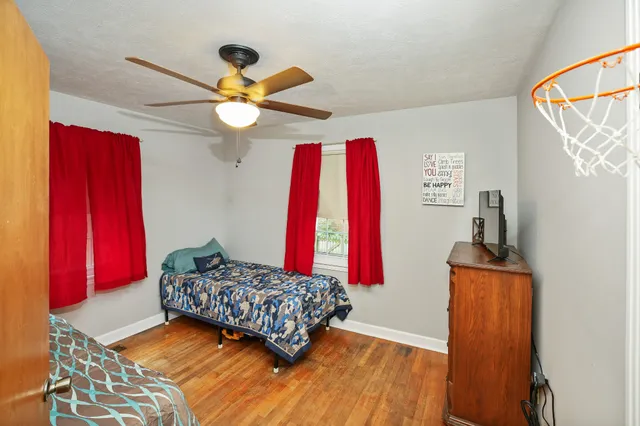 a bedroom with a bed and a chandelier