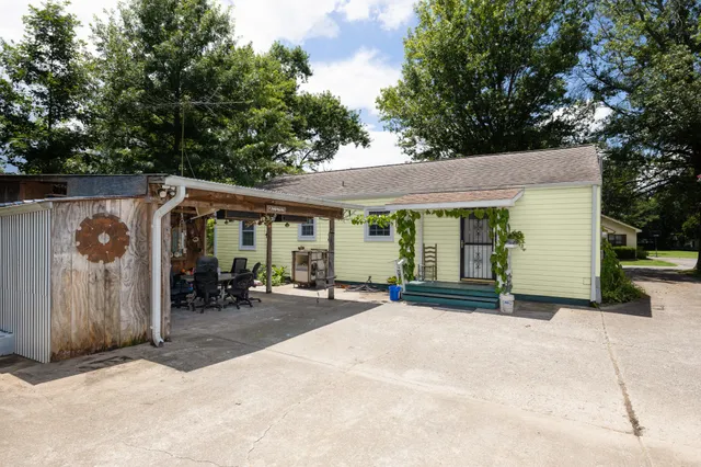 a view of a house with backyard porch and sitting area