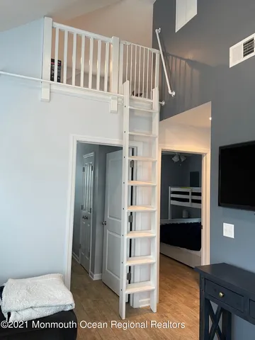 a view of a livingroom with furniture and staircase