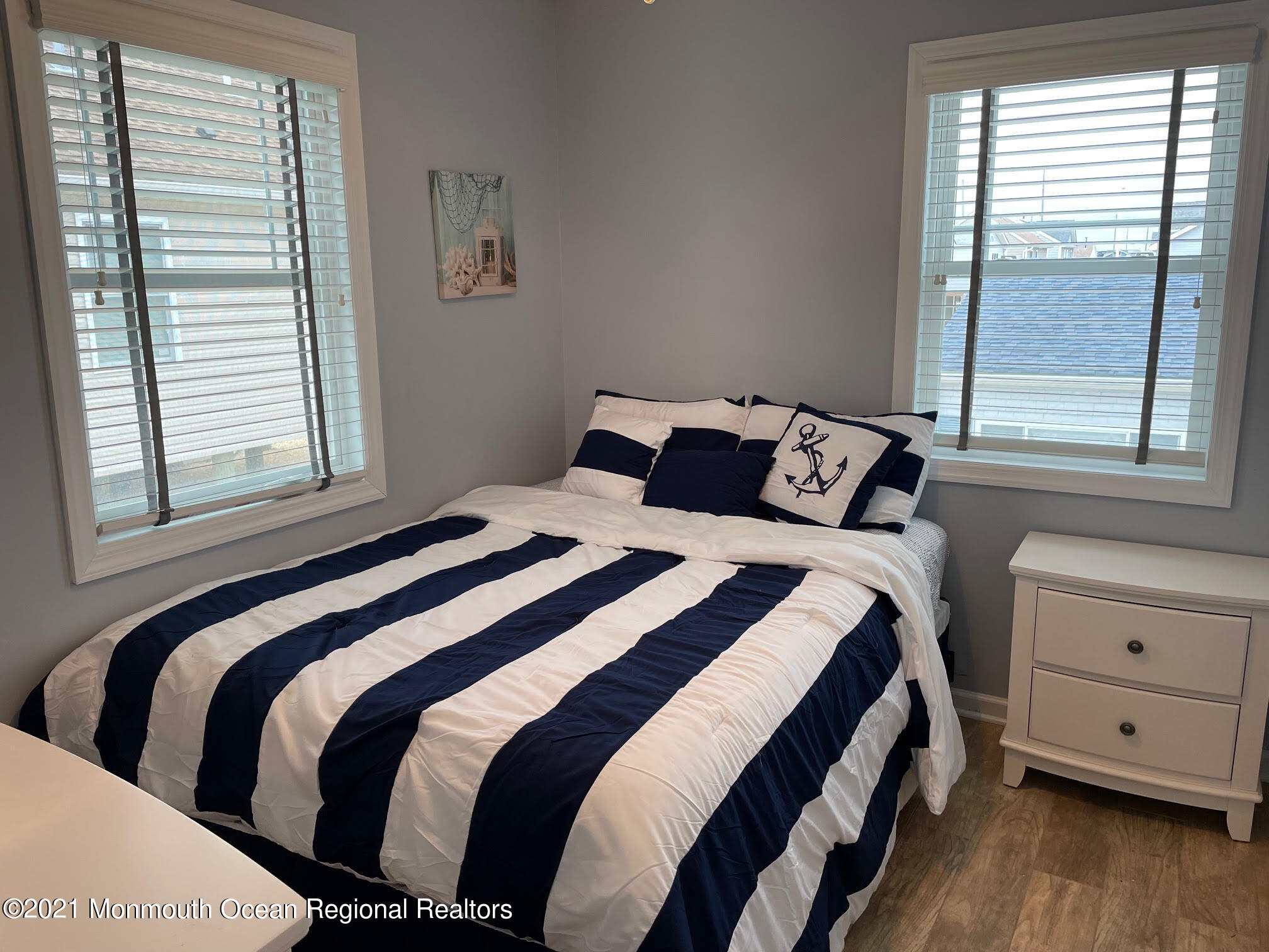 106 West Pompano Way Lavallette, NJ 08735 - Photo 6 of 27 a bedroom with a bed and wooden floor