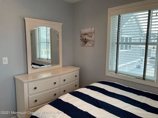 a room with a dresser and a window