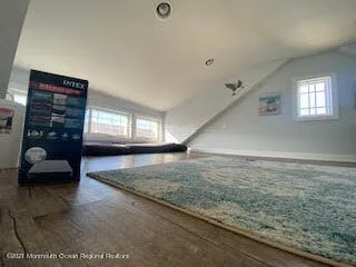 a view of a livingroom with furniture and a window