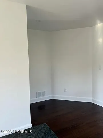 a room with a bench and wooden floor